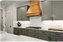 1069 Dean Hill Rd, Monroe, GA 30655 - kitchen featuring custom range hood and light countertops