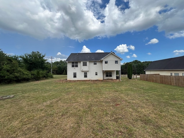 back of property featuring a lawn