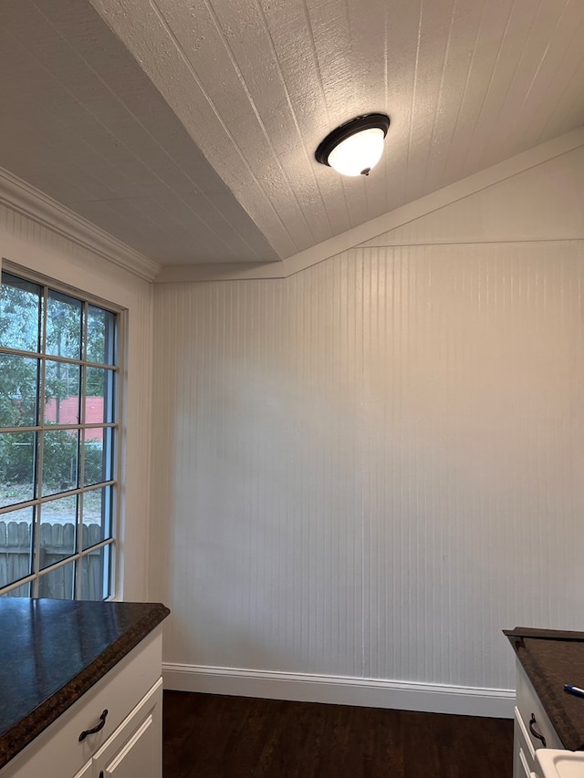 interior space with dark wood-type flooring and baseboards