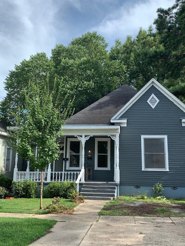 view of front of house featuring covered porch, roof with shingles, and crawl space