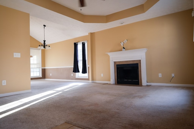 unfurnished living room featuring a fireplace with flush hearth, carpet flooring, and baseboards