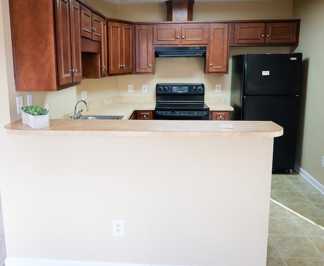 kitchen featuring a peninsula, exhaust hood, a sink, light countertops, and black appliances