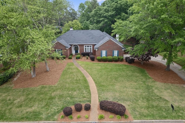 6426 Springwater Dr, Columbus, GA 31904 - traditional home with a chimney, brick siding, a front lawn, and a shingled roof