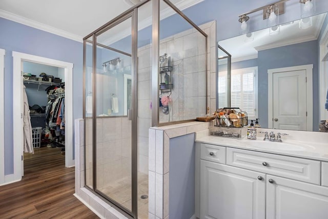 316 Birch Ln, Pine Mountain, GA 31822 - bathroom featuring crown molding, a shower stall, vanity, wood finished floors, and a spacious closet
