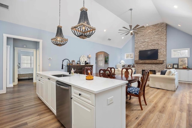 316 Birch Ln, Pine Mountain, GA 31822 - kitchen with a sink, dishwasher, light wood finished floors, white cabinets, and high vaulted ceiling