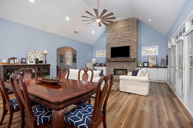 316 Birch Ln, Pine Mountain, GA 31822 - dining room with arched walkways, high vaulted ceiling, dark wood finished floors, a fireplace, and ceiling fan