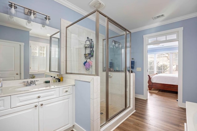 316 Birch Ln, Pine Mountain, GA 31822 - bathroom with ornamental molding, a stall shower, vanity, ensuite bath, and wood finished floors