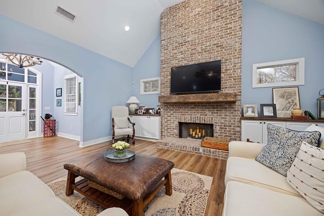 316 Birch Ln, Pine Mountain, GA 31822 - living room featuring high vaulted ceiling, wood finished floors, a chandelier, arched walkways, and baseboards