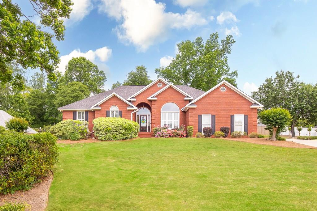 2902 Four Seasons Dr, Phenix City, AL 36867 - view of front of house with brick siding and a front lawn