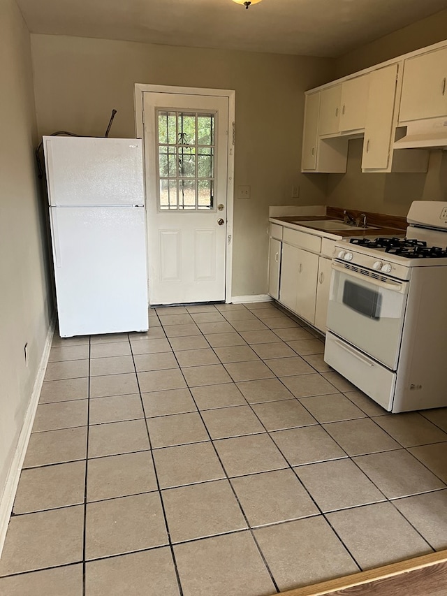 kitchen featuring white cabinetry, white appliances, and light tile patterned flooring