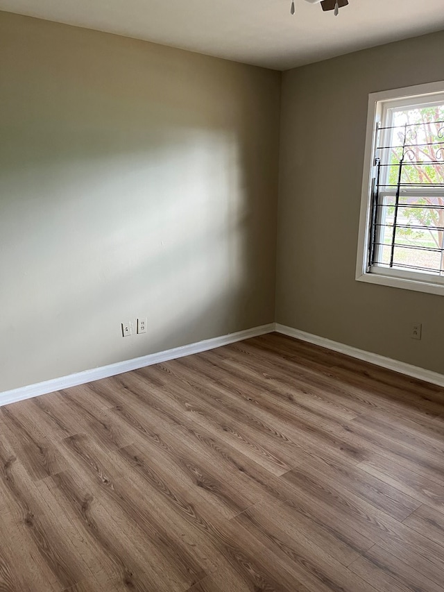 unfurnished room with hardwood / wood-style flooring and ceiling fan