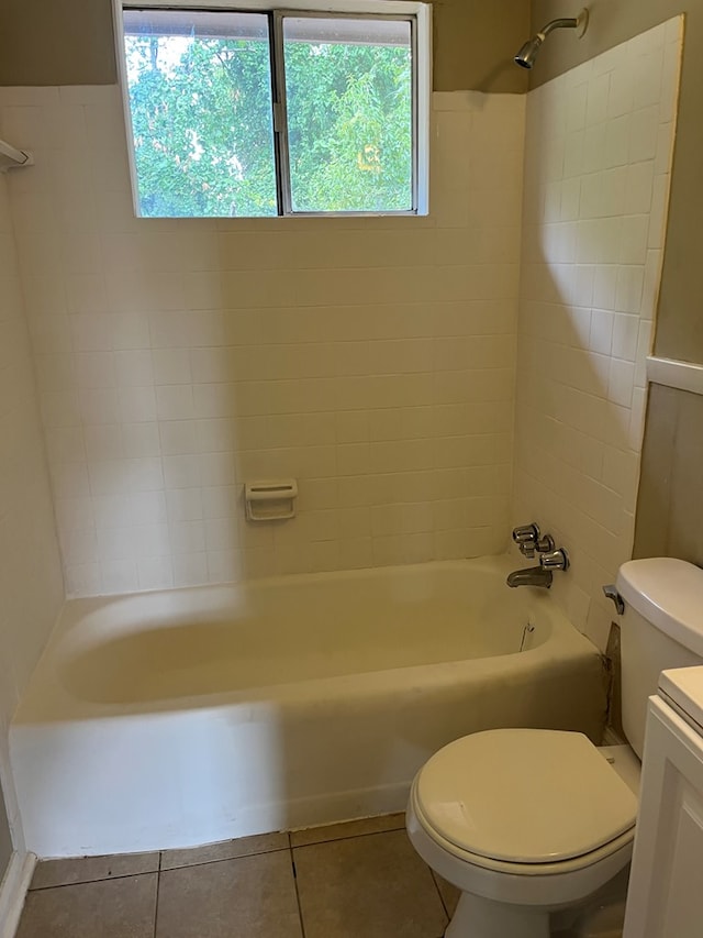 full bathroom featuring tile patterned flooring, vanity, toilet, and tiled shower / bath