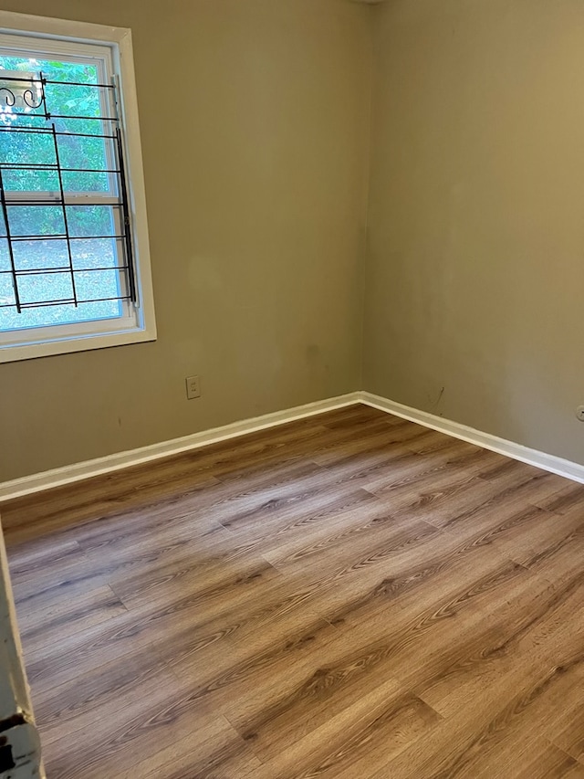 unfurnished room featuring hardwood / wood-style floors