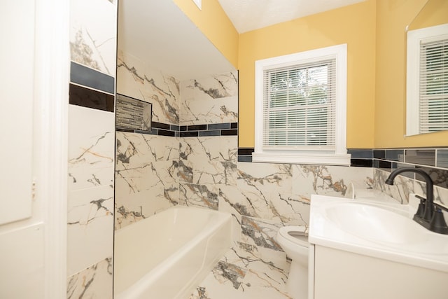 bathroom featuring a textured ceiling, vanity, tile walls, toilet, and a tub