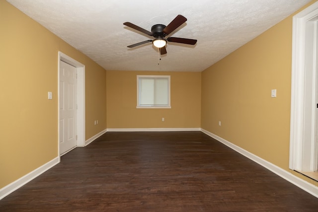 empty room featuring a textured ceiling, dark hardwood / wood-style floors, and ceiling fan