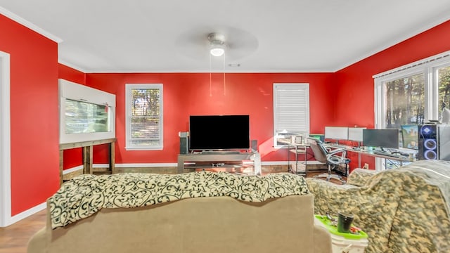 living room featuring hardwood / wood-style flooring, ceiling fan, and crown molding