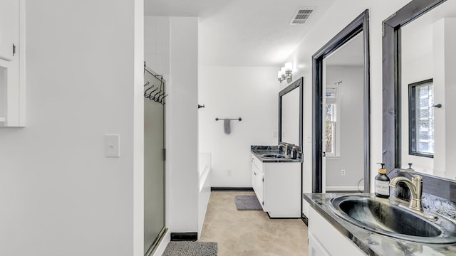 bathroom with shower with separate bathtub and vanity