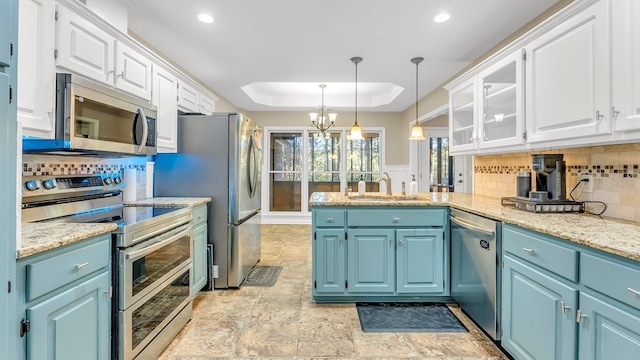 kitchen with blue cabinets, white cabinetry, sink, and appliances with stainless steel finishes