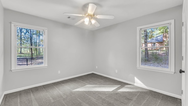 empty room with ceiling fan and carpet floors