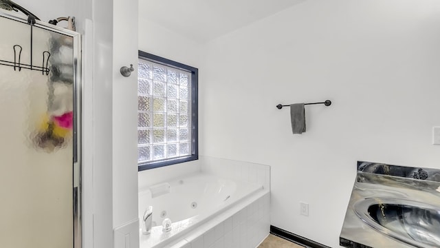 bathroom with a wealth of natural light and independent shower and bath