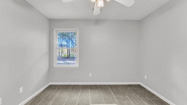 carpeted spare room featuring ceiling fan