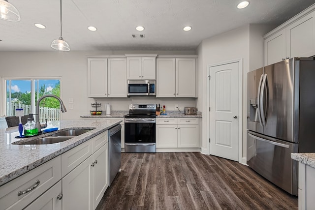 kitchen featuring white cabinets, visible vents, a sink, appliances with stainless steel finishes, and dark wood-style flooring