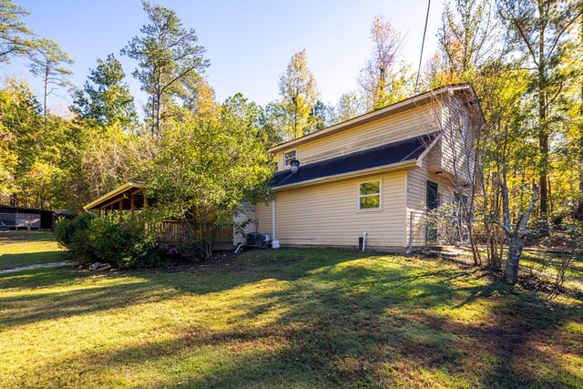 view of side of home featuring a lawn