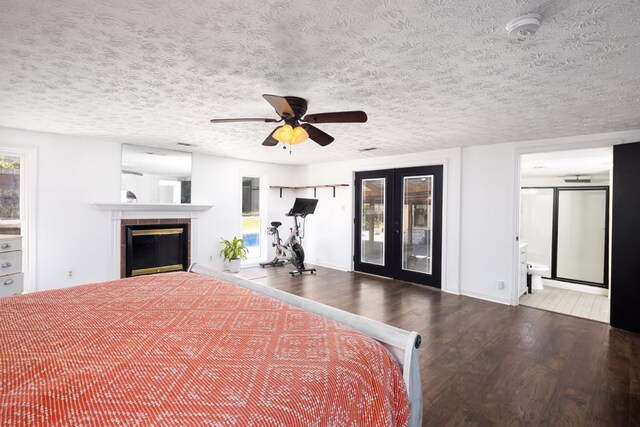 unfurnished bedroom with access to exterior, french doors, a textured ceiling, ceiling fan, and hardwood / wood-style flooring