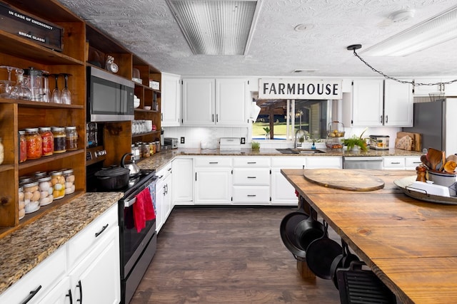 kitchen with sink, white cabinets, wooden counters, and appliances with stainless steel finishes