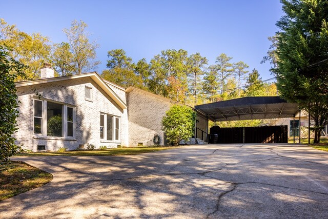 view of property exterior with a carport