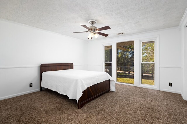 carpeted bedroom featuring ceiling fan, crown molding, and a textured ceiling