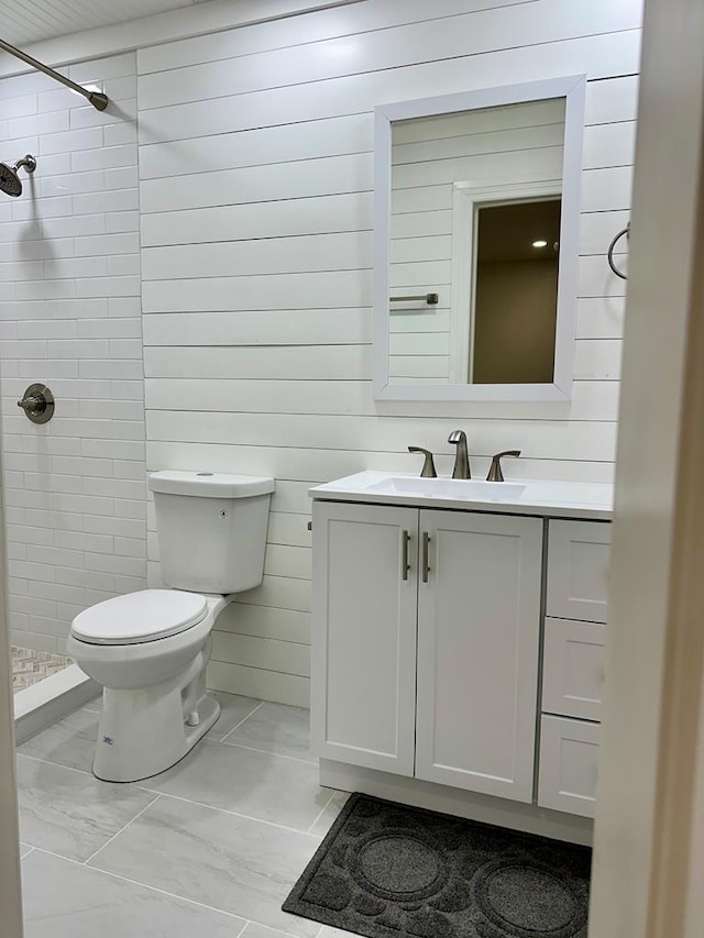 6231 Lynridge Ave, Columbus, GA 31909 - full bath featuring a stall shower, toilet, vanity, marble look tile flooring, and wood walls