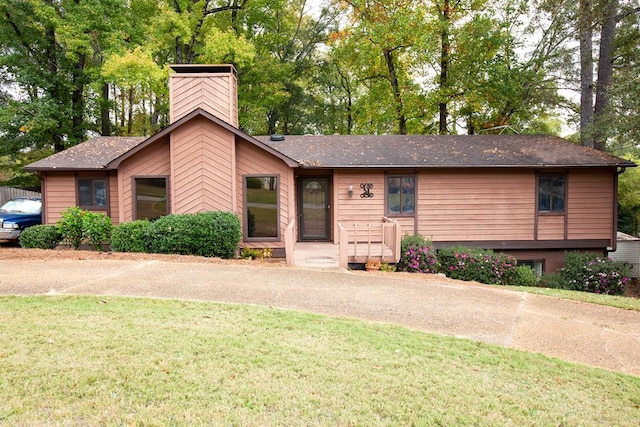 view of front of home featuring a front yard and a chimney