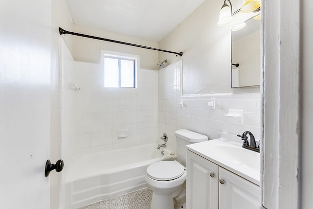 full bathroom featuring tile walls, tiled shower / bath combo, vanity, toilet, and tile patterned floors