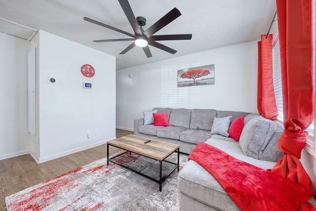 living room with hardwood / wood-style flooring, a textured ceiling, and ceiling fan