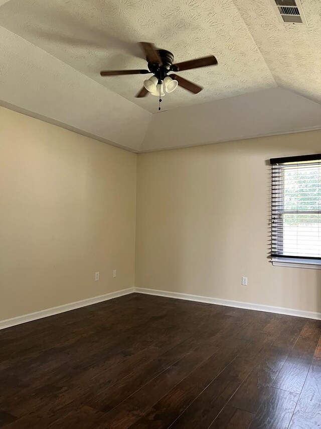 unfurnished room with a textured ceiling, dark hardwood / wood-style flooring, ceiling fan, and lofted ceiling