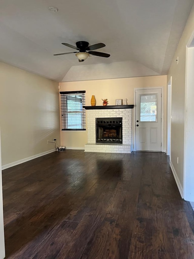 unfurnished living room with a brick fireplace, ceiling fan, wood-type flooring, and vaulted ceiling