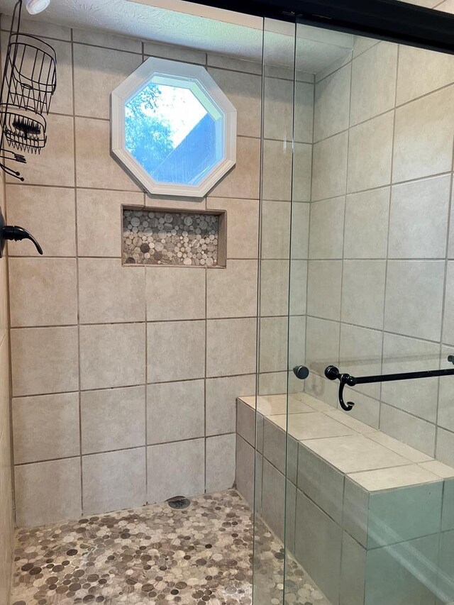 bathroom with a tile shower