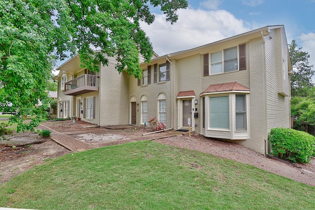 1305 Forest Ave Unit 00011, Columbus, GA 31906 - view of front of home featuring a balcony, a front lawn, and brick siding