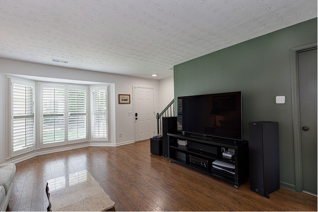 1305 Forest Ave Unit 00011, Columbus, GA 31906 - living room featuring plenty of natural light, wood finished floors, stairway, a textured ceiling, and baseboards
