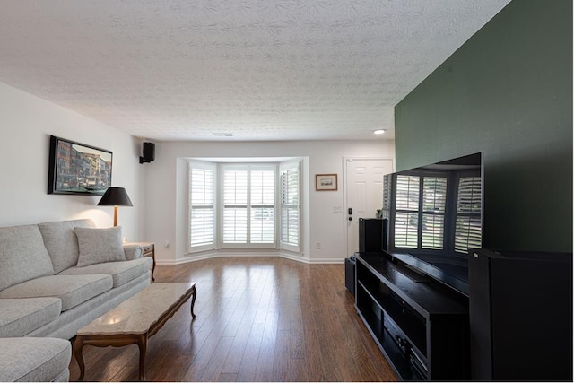 1305 Forest Ave Unit 00011, Columbus, GA 31906 - living room featuring a textured ceiling, dark wood-style flooring, and baseboards