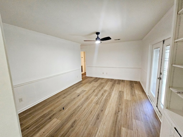 unfurnished room featuring ceiling fan, crown molding, and light hardwood / wood-style flooring