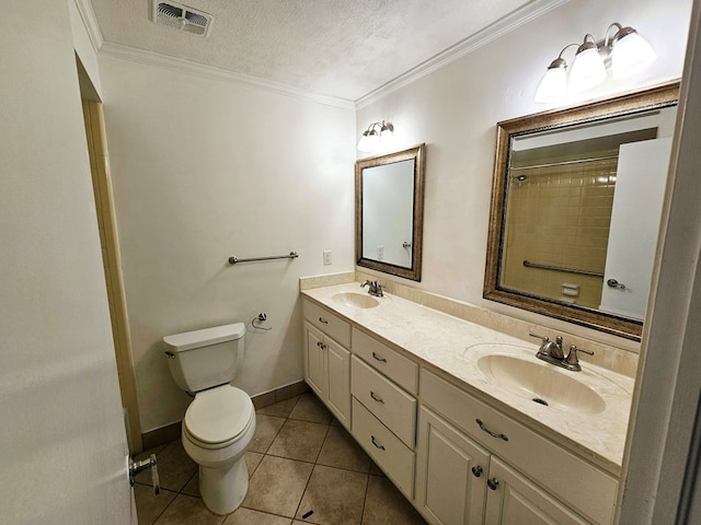 bathroom with tile patterned floors, crown molding, a textured ceiling, toilet, and vanity