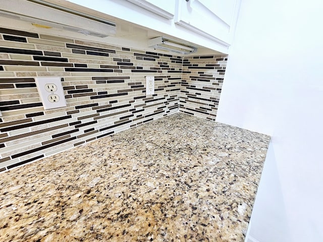 interior details with light stone countertops and tasteful backsplash