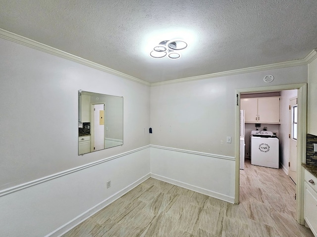 empty room with washer / clothes dryer, crown molding, and a textured ceiling