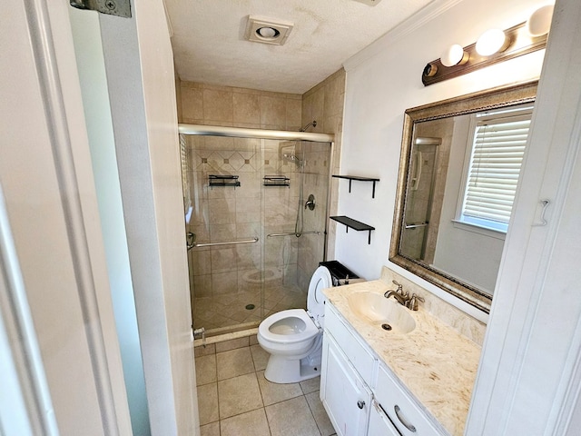 bathroom featuring tile patterned flooring, vanity, toilet, and an enclosed shower