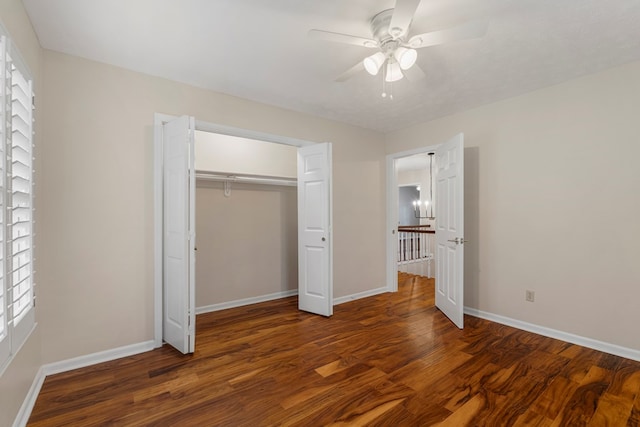 unfurnished bedroom with ceiling fan, a closet, baseboards, and wood finished floors