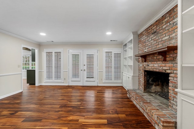 living area with a fireplace, crown molding, baseboards, and wood finished floors