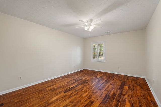 unfurnished room featuring visible vents, a textured ceiling, baseboards, ceiling fan, and dark wood-style flooring