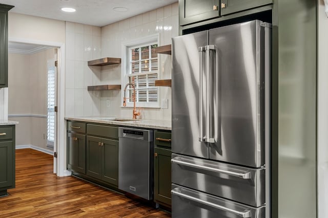 kitchen with light stone counters, open shelves, a sink, stainless steel appliances, and dark wood-type flooring